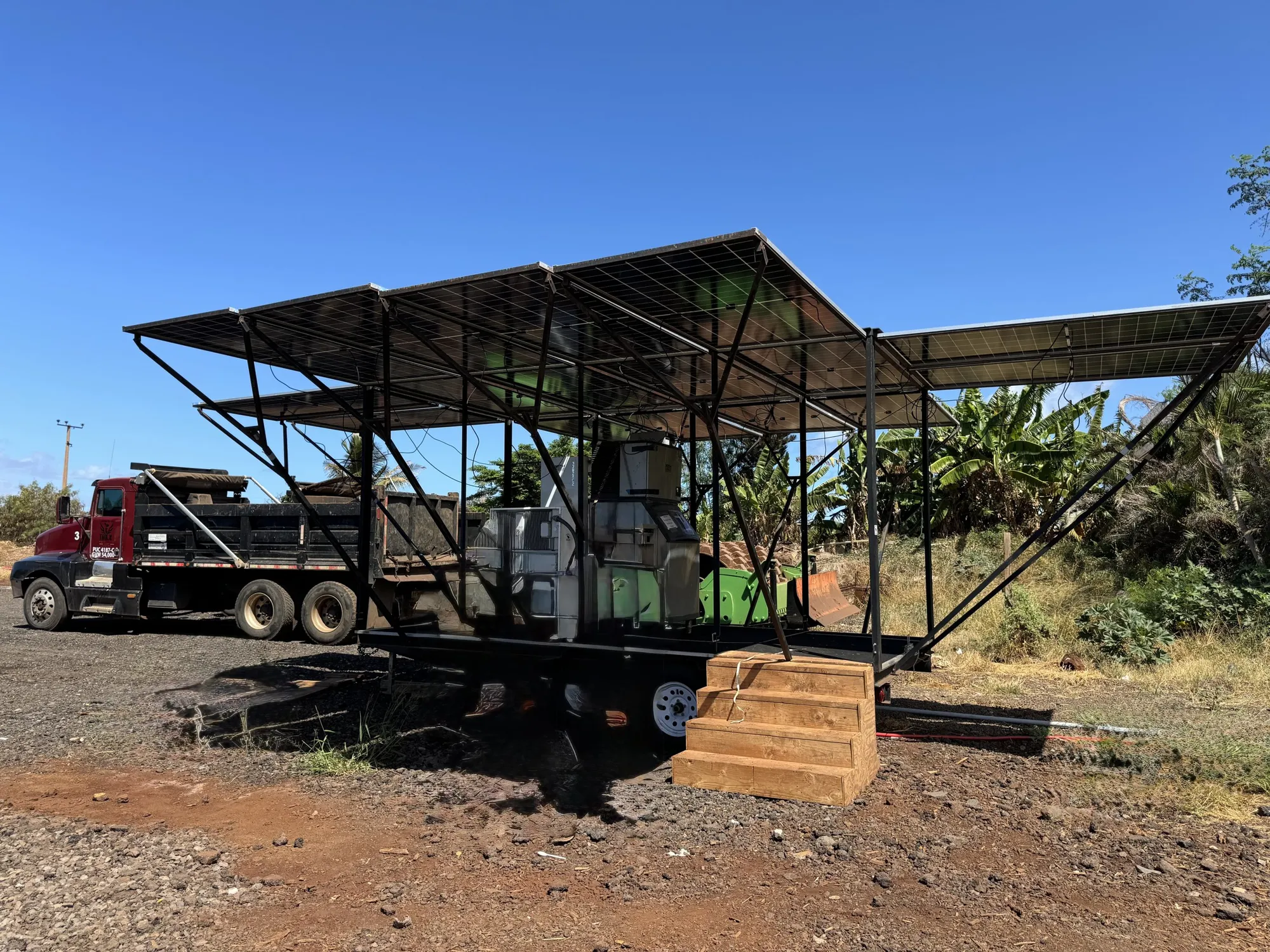 The Power Cube deployed on a Maui job site with its solar canopy unfolded