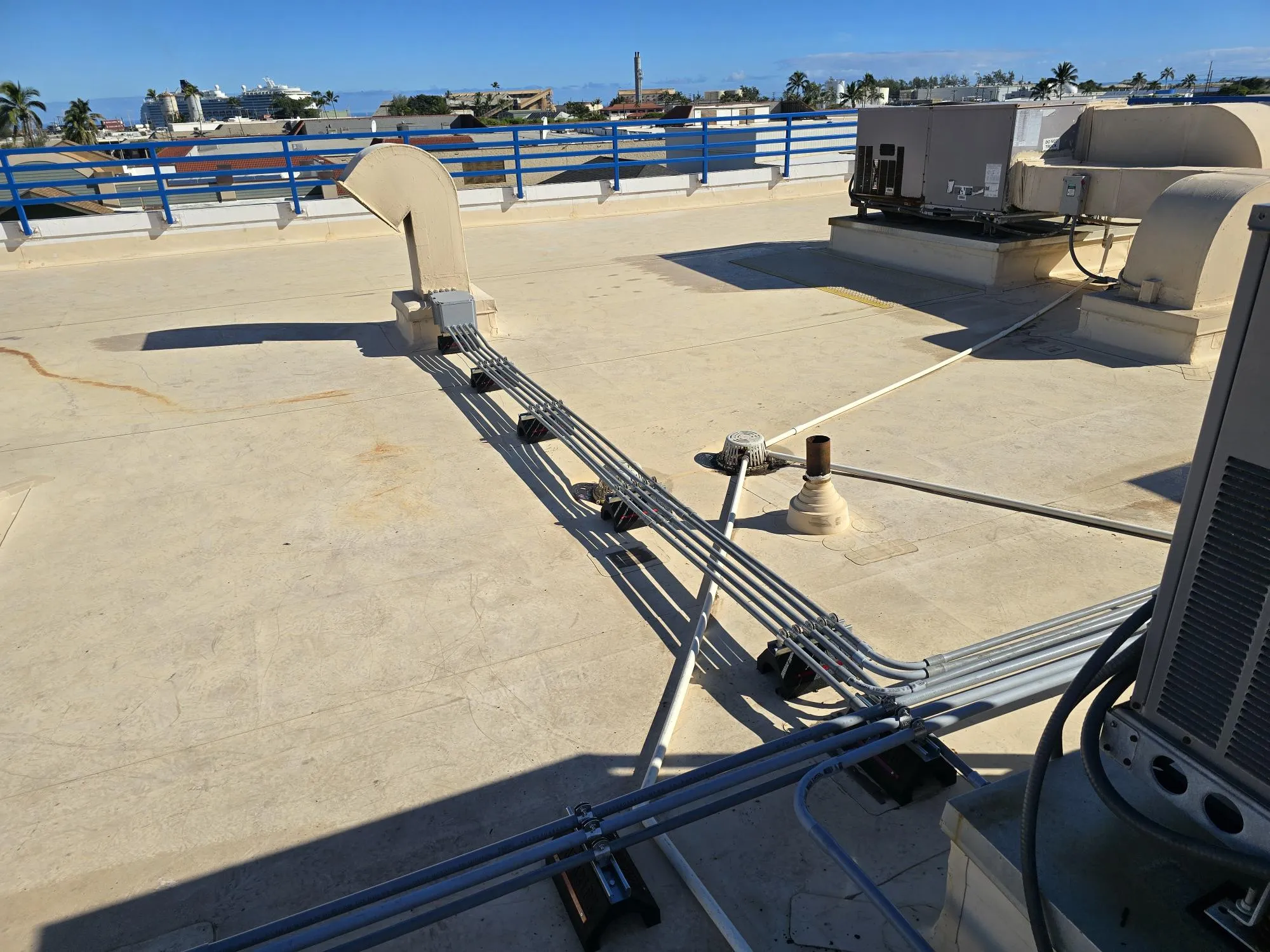 Conduit runs to rooftop equipment on a commercial building